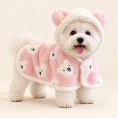 White bichon wearing the pink bear hooded pet blanket cape with plush trim and rounded hood ears