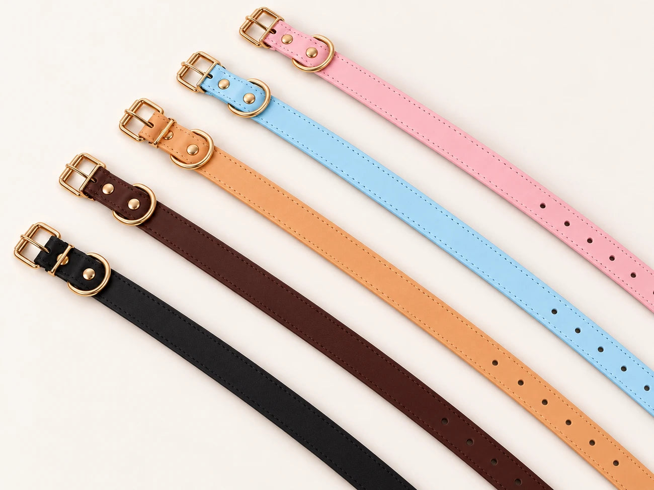 Five plain collar straps in pink, blue, tan, brown and black with gold buckles